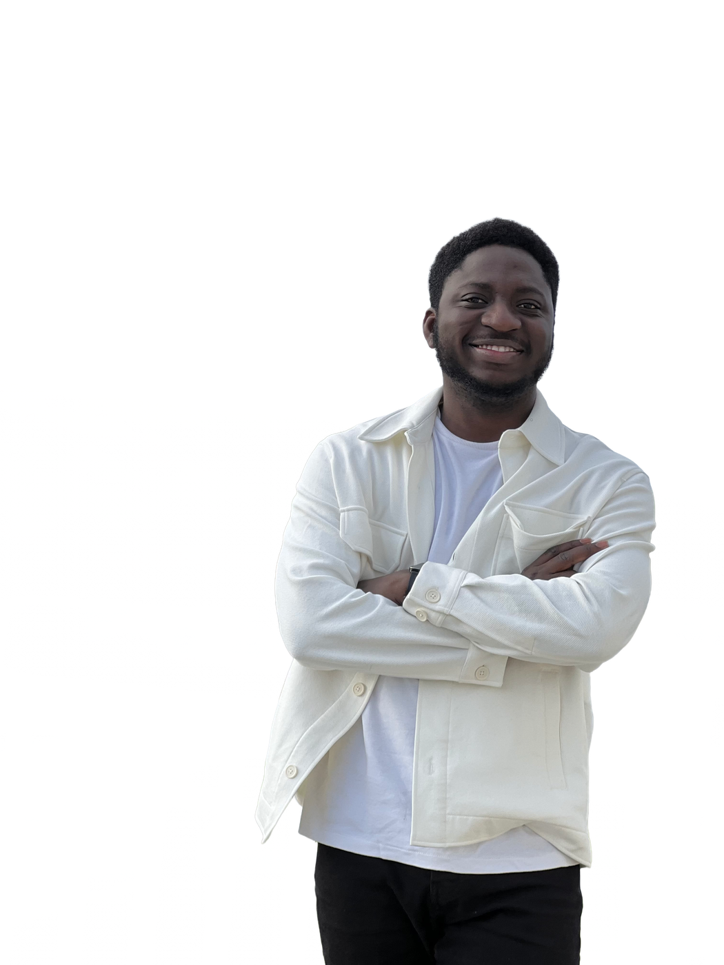 Michael Akintayo in a cream jacket with arms folded