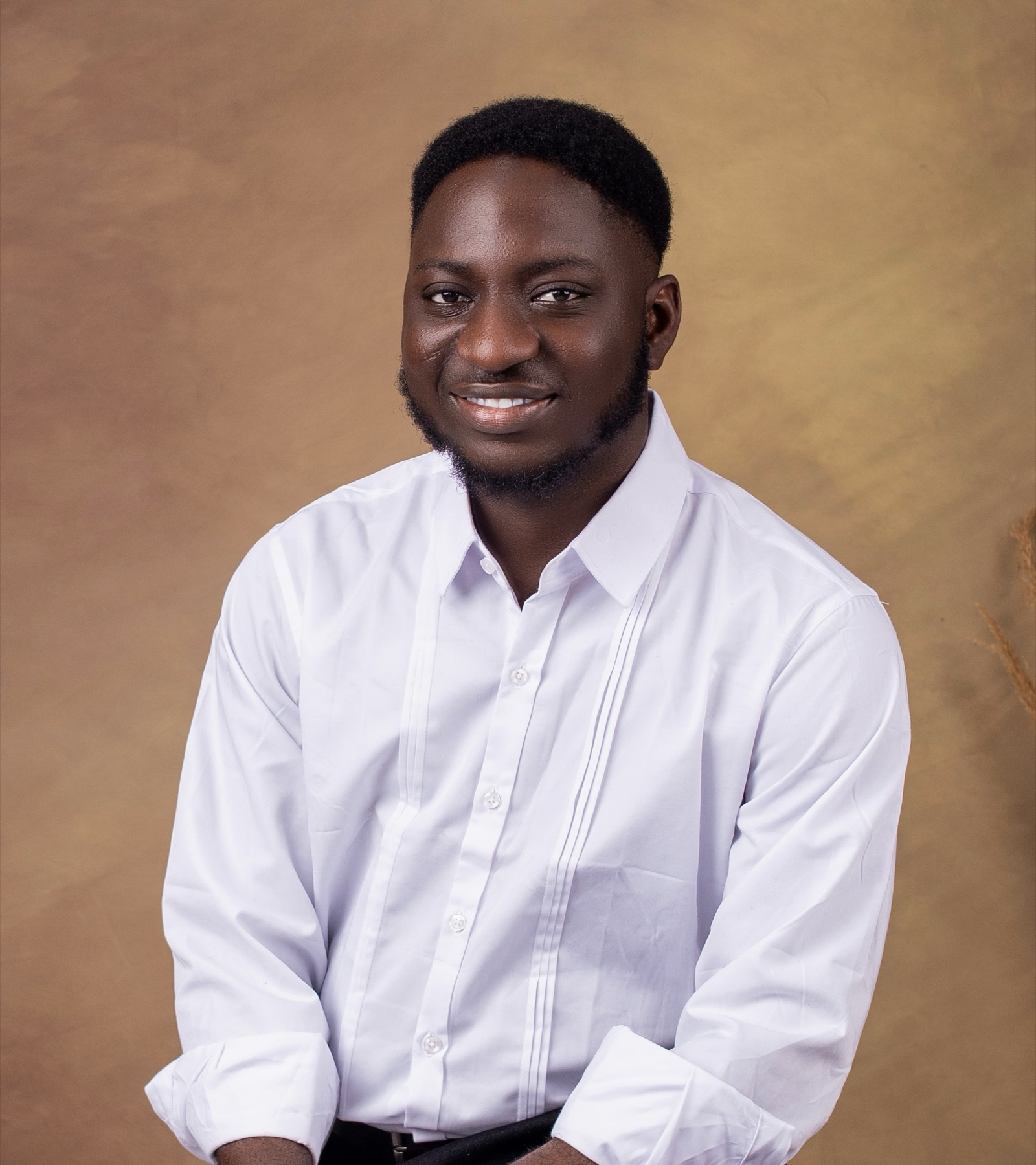 Michael Akintayo studio portrait in a white shirt